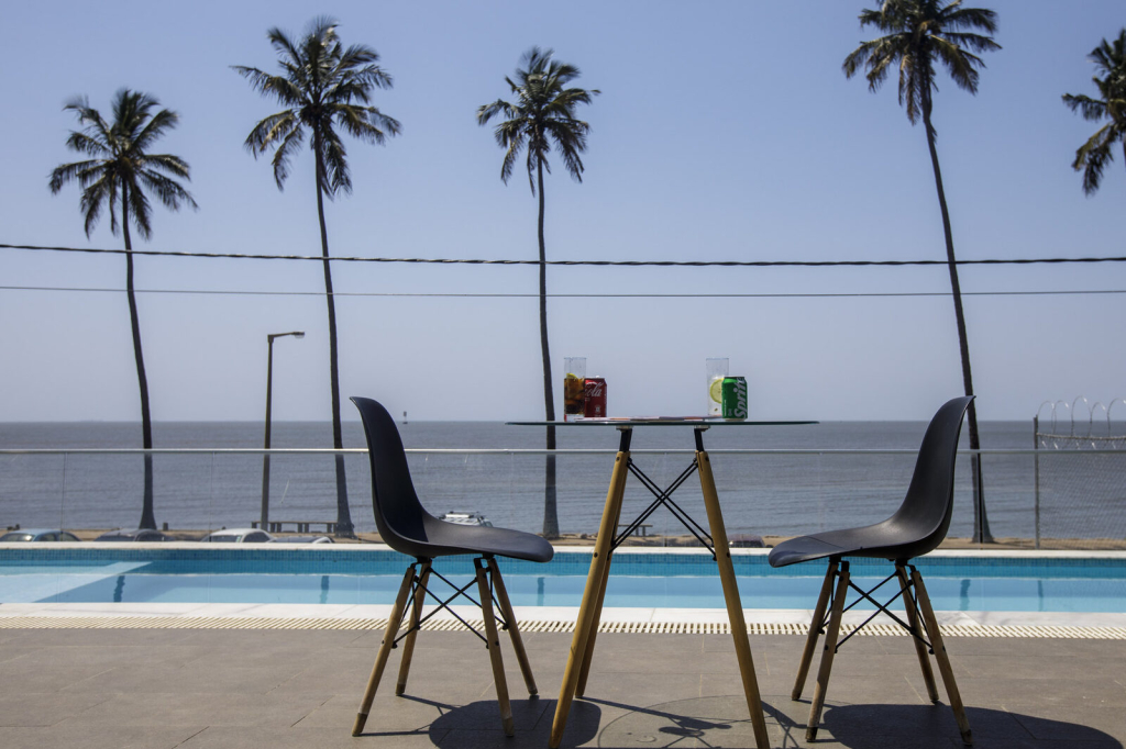 Mesa para dois junto à piscina, virada para o mar, nas CoWork Lab Suites